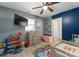 Bright bedroom featuring a colorful rug, bright windows, and closet at 443 Picadilly Ln, Troutman, NC 28166