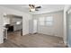 Bright dining area features a ceiling fan, window, and vinyl flooring that connect to an adjacent kitchen at 443 Picadilly Ln, Troutman, NC 28166