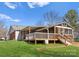 A view of the house with a deck overlooking the backyard, showcasing outdoor living space at 443 Picadilly Ln, Troutman, NC 28166