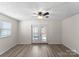 Bright and spacious living room featuring a ceiling fan and access to patio at 443 Picadilly Ln, Troutman, NC 28166