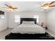 Bedroom featuring a large bed, ceiling fans, bright windows and neutral colors at 443 Picadilly Ln, Troutman, NC 28166