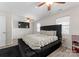 Comfortable bedroom featuring a large bed, ceiling fan, and bright windows at 443 Picadilly Ln, Troutman, NC 28166