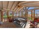 Bright screened in sunroom featuring a ceiling fan, stylish seating and wood floors at 443 Picadilly Ln, Troutman, NC 28166