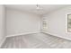 A simple bedroom featuring gray carpet, a ceiling fan and two windows at 5230 Club View Dr, Concord, NC 28025