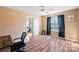 Bright bedroom with hardwood floors, window, and a view of another room at 5702 Prescott Ct, Charlotte, NC 28269