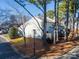 Rear view of townhome showcasing private backyard and tall trees at 5702 Prescott Ct, Charlotte, NC 28269
