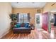 Bright living room with hardwood floors, red door, and a gray couch at 5702 Prescott Ct, Charlotte, NC 28269