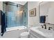 Modern bathroom with blue tile, a soaking tub, and a floating vanity at 6108 Raven Rock Dr, Denver, NC 28037