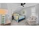 Bright bedroom with a metal bed frame and an accent chair at 6531 Wildbrook Dr, Charlotte, NC 28269