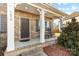 Brick home with rocking chairs on the front porch at 7070 Founders Way, Harrisburg, NC 28075