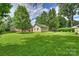 Expansive backyard features mature trees and a basketball court, perfect for outdoor activities and relaxation at 7135 Folger Dr, Charlotte, NC 28270