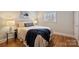 Cozy bedroom featuring hardwood floors, a queen bed, and soft, natural light from the window at 7135 Folger Dr, Charlotte, NC 28270