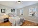 Serene bedroom with neutral decor, wood floors, and bright natural light at 7135 Folger Dr, Charlotte, NC 28270
