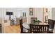 Open-concept dining room featuring hardwood floors, wood chairs, and views into the living room at 7135 Folger Dr, Charlotte, NC 28270
