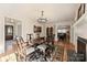 Elegant dining room boasting a fireplace, wooden table with seating, and bright lighting at 7135 Folger Dr, Charlotte, NC 28270