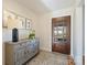 Hardwood floor entryway, featuring a decorative console table and mirror at 7135 Folger Dr, Charlotte, NC 28270