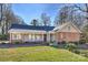 Brick ranch home with updated exterior and landscaped lawn at 7135 Folger Dr, Charlotte, NC 28270