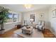 Bright sitting room with hardwood floors, large windows, and elegant decor at 7135 Folger Dr, Charlotte, NC 28270