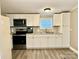 Bright kitchen featuring white cabinets, stainless steel appliances, and vinyl flooring at 758 Shannon Meadows Rd, Clover, SC 29710