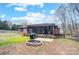 Wide view of the backyard, including patio, fire pit, and access to the screened-in porch at 8115 Kingsland Dr, Waxhaw, NC 28173