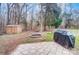 Backyard with an outdoor storage shed, stone fire pit, and patio area, perfect for entertaining at 8115 Kingsland Dr, Waxhaw, NC 28173