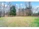 Large private backyard with a storage shed surrounded by mature trees at 8115 Kingsland Dr, Waxhaw, NC 28173