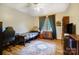 Comfortable bedroom featuring hardwood floors, fan, and a large window with natural light at 8115 Kingsland Dr, Waxhaw, NC 28173