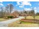 Attractive home with a gravel driveway, enhanced landscaping, and mature trees at 8115 Kingsland Dr, Waxhaw, NC 28173