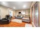 Cozy living room featuring hardwood floors, comfortable seating, and a sliding glass door at 8115 Kingsland Dr, Waxhaw, NC 28173