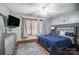 Cozy main bedroom features a comfortable bed, wood flooring, and a ceiling fan at 8115 Kingsland Dr, Waxhaw, NC 28173