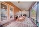 Relaxing screened porch with comfortable seating, ceiling fan, and wooded view at 8115 Kingsland Dr, Waxhaw, NC 28173