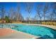 Community swimming pool with lake view and surrounding trees at 900 Raffaelo Vw, Mount Holly, NC 28120