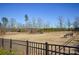 Community dog park with fenced area, benches and lake view at 900 Raffaelo Vw, Mount Holly, NC 28120