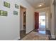 Bright entryway with hardwood floors, red door, and artwork on the wall at 900 Raffaelo Vw, Mount Holly, NC 28120