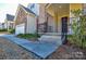 House exterior showcasing a walkway to the front door and landscaping at 900 Raffaelo Vw, Mount Holly, NC 28120