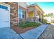 Brick house exterior with a covered porch and landscaped front yard at 900 Raffaelo Vw, Mount Holly, NC 28120