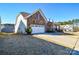 Two-car garage with attached driveway and stone exterior at 900 Raffaelo Vw, Mount Holly, NC 28120