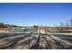 Community tennis courts with lake and homes in background at 900 Raffaelo Vw, Mount Holly, NC 28120