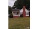 Charming white house with red brick accents and a spacious lawn at 903 Belmont Mount Holly Rd, Belmont, NC 28012