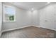 This bedroom has gray walls, hardwood floors, and a window to let light in at 9657 Liberty Hill Dr, Mint Hill, NC 28227