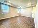 Bright bedroom with hardwood floors and two windows providing plenty of natural light at 9657 Liberty Hill Dr, Mint Hill, NC 28227