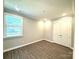 Cozy bedroom with wood-look floors, window and closet with double doors at 9657 Liberty Hill Dr, Mint Hill, NC 28227