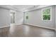 Neutral-toned bedroom with bright windows, tray ceiling and en-suite bath at 9657 Liberty Hill Dr, Mint Hill, NC 28227