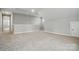 Large bonus room with neutral carpet and trim, as well as natural light at 9657 Liberty Hill Dr, Mint Hill, NC 28227