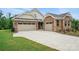 A charming brick home with a three-car garage, wide driveway, and well-maintained lawn on a sunny day at 9657 Liberty Hill Dr, Mint Hill, NC 28227