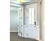 Bright foyer with hardwood floors, leading to an office through glass paneled doors, and front door at 9657 Liberty Hill Dr, Mint Hill, NC 28227