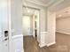 Hallway with classic white trim and modern luxury vinyl plank flooring at 9657 Liberty Hill Dr, Mint Hill, NC 28227