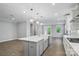 An open-concept kitchen with a gray island, white countertops, and stainless steel appliances at 9657 Liberty Hill Dr, Mint Hill, NC 28227