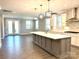 Open-concept kitchen boasts a center island, pendant lights, and easy access to the outdoor living space at 9657 Liberty Hill Dr, Mint Hill, NC 28227