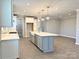 Spacious kitchen features a central island, stainless steel appliances, and seamless flow to the living area at 9657 Liberty Hill Dr, Mint Hill, NC 28227
